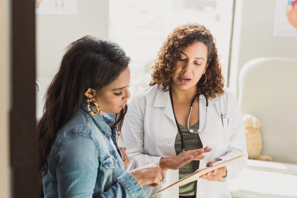 Pediatrician talks with patient’s mother