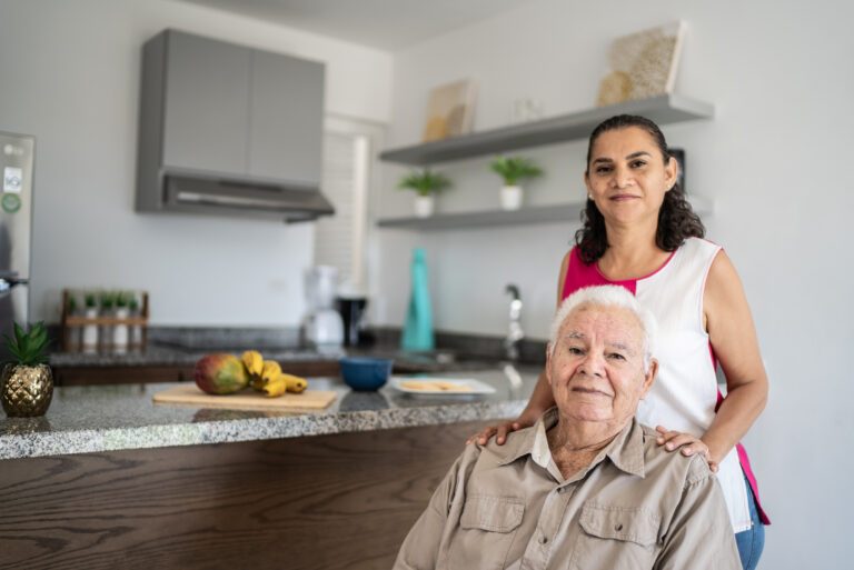 Portrait of senior man and his daughter (or home caregiver) at home