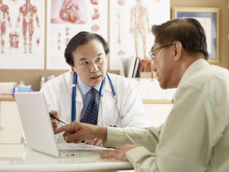 Asian male doctor talking to patient