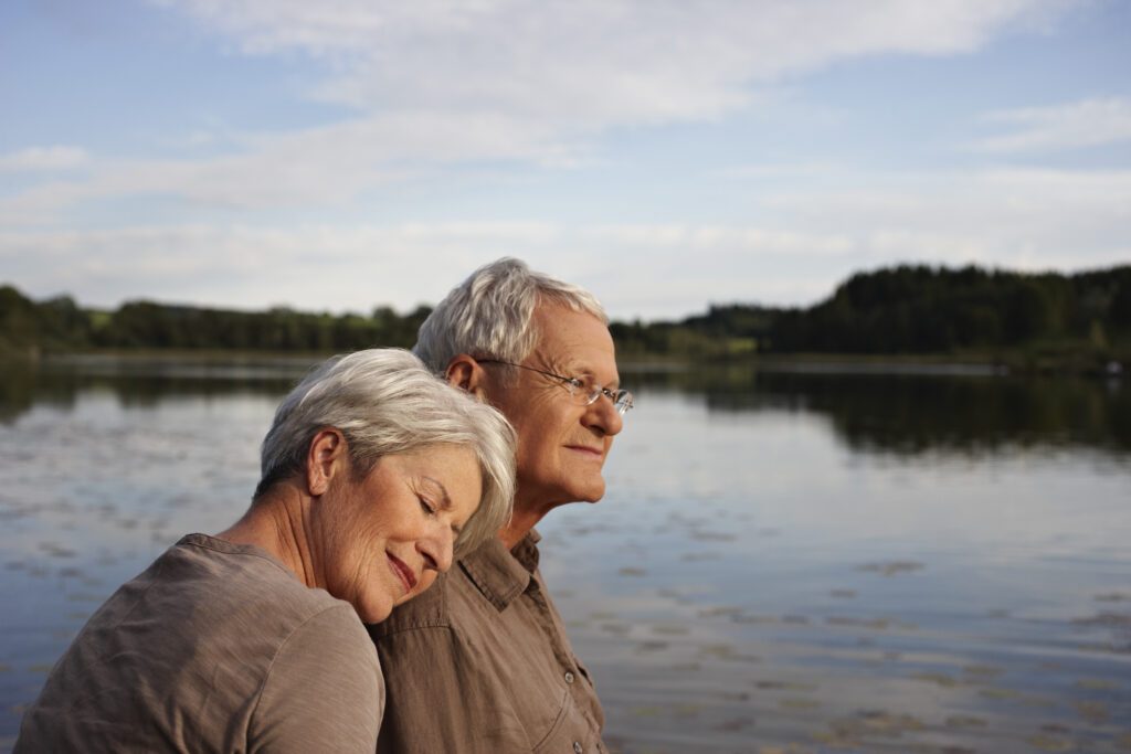 Senior woman lying head on mans shoulder